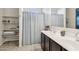 Bright bathroom with a double sink vanity and shower at 25634 W Samantha Way, Buckeye, AZ 85326