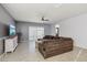 Open-concept living room boasting tile floors, a ceiling fan, and a comfortable sofa at 25634 W Samantha Way, Buckeye, AZ 85326