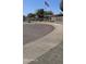 View of the gated entrance into Bethany Crest Cooperative with American flag and landscaping at 2616 W Berridge Ln # C2, Phoenix, AZ 85017