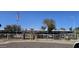 Exterior of Bethany Crest Cooperative, showcasing manicured lawns, an American flag, and well-maintained buildings at 2616 W Berridge Ln # C2, Phoenix, AZ 85017