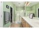 Bright bathroom featuring a glass shower, double sinks, and neutral tile floors at 26237 W Vista North Dr, Buckeye, AZ 85396