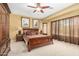 Cozy bedroom featuring a ceiling fan, carpet floors, and ensuite bathroom at 26237 W Vista North Dr, Buckeye, AZ 85396