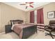 Comfortable bedroom with ceiling fan, carpeted floor, and desk with chair at 26237 W Vista North Dr, Buckeye, AZ 85396