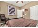 Cozy bedroom featuring carpet floors, ceiling fan, and a comfy desk chair at 26237 W Vista North Dr, Buckeye, AZ 85396