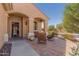 Inviting covered front porch with brick pavers and comfortable seating area at 26237 W Vista North Dr, Buckeye, AZ 85396