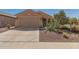 Beautifully landscaped single-story home featuring desert landscaping and a two car garage at 26237 W Vista North Dr, Buckeye, AZ 85396