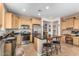 Kitchen with stainless steel appliances, granite countertops, light wood cabinets, and breakfast bar at 26237 W Vista North Dr, Buckeye, AZ 85396