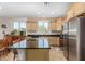 Bright kitchen featuring stainless steel appliances, an island with seating and light wood cabinets at 26237 W Vista North Dr, Buckeye, AZ 85396