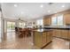 Bright kitchen with island seating, flowing to dining and living spaces creating a welcoming atmosphere at 26237 W Vista North Dr, Buckeye, AZ 85396