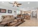 Open-concept living area with cozy furnishings, ceiling fan, and seamless flow to the kitchen at 26237 W Vista North Dr, Buckeye, AZ 85396