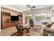 Inviting living room with neutral tones, tile floors, ceiling fan, and sliding doors to backyard at 26237 W Vista North Dr, Buckeye, AZ 85396