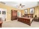 Bedroom featuring carpet floors, ceiling fan, and wood furniture at 26237 W Vista North Dr, Buckeye, AZ 85396