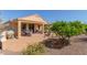 Covered patio with outdoor seating and a decorative rock landscape at 26237 W Vista North Dr, Buckeye, AZ 85396