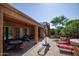 Outdoor back patio area with built-in seating, patio furniture, and attractive landscaping at 26293 W Runion Ln, Buckeye, AZ 85396