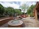 A private outdoor retreat with built-in seating area and waterfall is the perfect spot to unwind at 26293 W Runion Ln, Buckeye, AZ 85396
