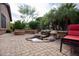 Backyard patio with rock waterfall, built-in bench, desert landscaping, and seating at 26293 W Runion Ln, Buckeye, AZ 85396