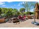 Backyard patio features a rock waterfall, lounge chairs and a built-in barbecue at 26293 W Runion Ln, Buckeye, AZ 85396