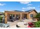 Wide angle showing the covered patio with lounge seating, firepit and outdoor kitchen at 26293 W Runion Ln, Buckeye, AZ 85396