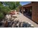 Beautiful backyard featuring a covered patio, built-in barbecue, and decorative fountain feature at 26293 W Runion Ln, Buckeye, AZ 85396