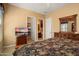 Bedroom featuring queen bed, dresser, TV, walk-in closet, and ensuite bath at 26293 W Runion Ln, Buckeye, AZ 85396