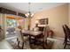 Formal dining room features rustic wood table and sliding glass doors to outdoor patio at 26293 W Runion Ln, Buckeye, AZ 85396