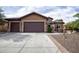 Charming single-story home with a spacious driveway and a well-maintained desert landscape at 26293 W Runion Ln, Buckeye, AZ 85396