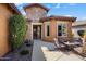 Inviting single-story home with a covered front porch and beautiful landscaping and outdoor fireplace at 26293 W Runion Ln, Buckeye, AZ 85396