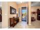 Foyer area featuring tile flooring, wood console table, and secure front door at 26293 W Runion Ln, Buckeye, AZ 85396