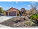 Charming single-story home with a well-manicured desert landscaped yard and a three-car garage at 26293 W Runion Ln, Buckeye, AZ 85396