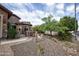 Charming landscaped front yard with a stone-accented walkway, desert plants, and decorative elements at 26293 W Runion Ln, Buckeye, AZ 85396