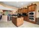 Modern kitchen with island, stainless steel appliances, and ample cabinet space, perfect for cooking at 26293 W Runion Ln, Buckeye, AZ 85396