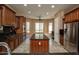 Open-concept kitchen with stainless steel appliances, island, and ample cabinet space at 26293 W Runion Ln, Buckeye, AZ 85396