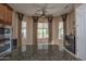 Bright, airy living room filled with natural light from large windows, ceiling fan, and designer curtains at 26293 W Runion Ln, Buckeye, AZ 85396