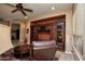 Spacious living room with a built-in media center, leather furniture, and a ceiling fan at 26293 W Runion Ln, Buckeye, AZ 85396