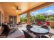 Covered patio featuring wicker seating, ceiling fan, and a view of the backyard at 26293 W Runion Ln, Buckeye, AZ 85396