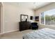 Bedroom featuring an accent chair, a dresser, television, and a window at 26797 W Sierra Pinta Dr, Buckeye, AZ 85396