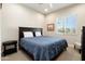 Comfortable bedroom with a large window, ceiling fan and neutral decor at 26797 W Sierra Pinta Dr, Buckeye, AZ 85396