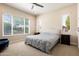 Bright bedroom featuring carpet, many windows, and neutral tones at 26797 W Sierra Pinta Dr, Buckeye, AZ 85396