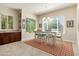 Bright dining area with natural light, a modern light fixture and a dining table at 26797 W Sierra Pinta Dr, Buckeye, AZ 85396