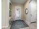 Bright foyer featuring a decorative rug, a bench, and a glass front door at 26797 W Sierra Pinta Dr, Buckeye, AZ 85396