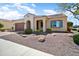 Single-story home with desert landscaping, light stucco, and a brown garage door at 26797 W Sierra Pinta Dr, Buckeye, AZ 85396