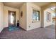 Inviting front porch showcasing a decorative front door and covered entryway with decorative rug at 26797 W Sierra Pinta Dr, Buckeye, AZ 85396