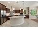 This gourmet kitchen features stainless steel appliances, granite counters, and pendant lighting at 26797 W Sierra Pinta Dr, Buckeye, AZ 85396