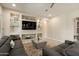 Inviting living room showcasing a contemporary sofa, built-in shelving, and stylish decor at 26797 W Sierra Pinta Dr, Buckeye, AZ 85396