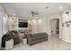 Bright living room featuring comfortable seating, a built-in entertainment center, and an open layout at 26797 W Sierra Pinta Dr, Buckeye, AZ 85396