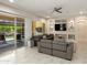 Spacious living room featuring modern furniture, a ceiling fan, and built in shelving at 26797 W Sierra Pinta Dr, Buckeye, AZ 85396