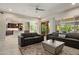 Spacious living room adjacent to the kitchen, featuring comfortable seating and sliding glass doors at 26797 W Sierra Pinta Dr, Buckeye, AZ 85396