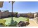 A backyard with a putting green, palm trees, and well-manicured landscaping at 2813 W Hiddenview Dr, Phoenix, AZ 85045