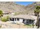 Desert home features a private pool, a putting green, stone waterfall and lounge seating at 2813 W Hiddenview Dr, Phoenix, AZ 85045