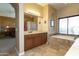 Bathroom featuring a large vanity, soaking tub with tile surround, and travertine flooring at 2813 W Hiddenview Dr, Phoenix, AZ 85045